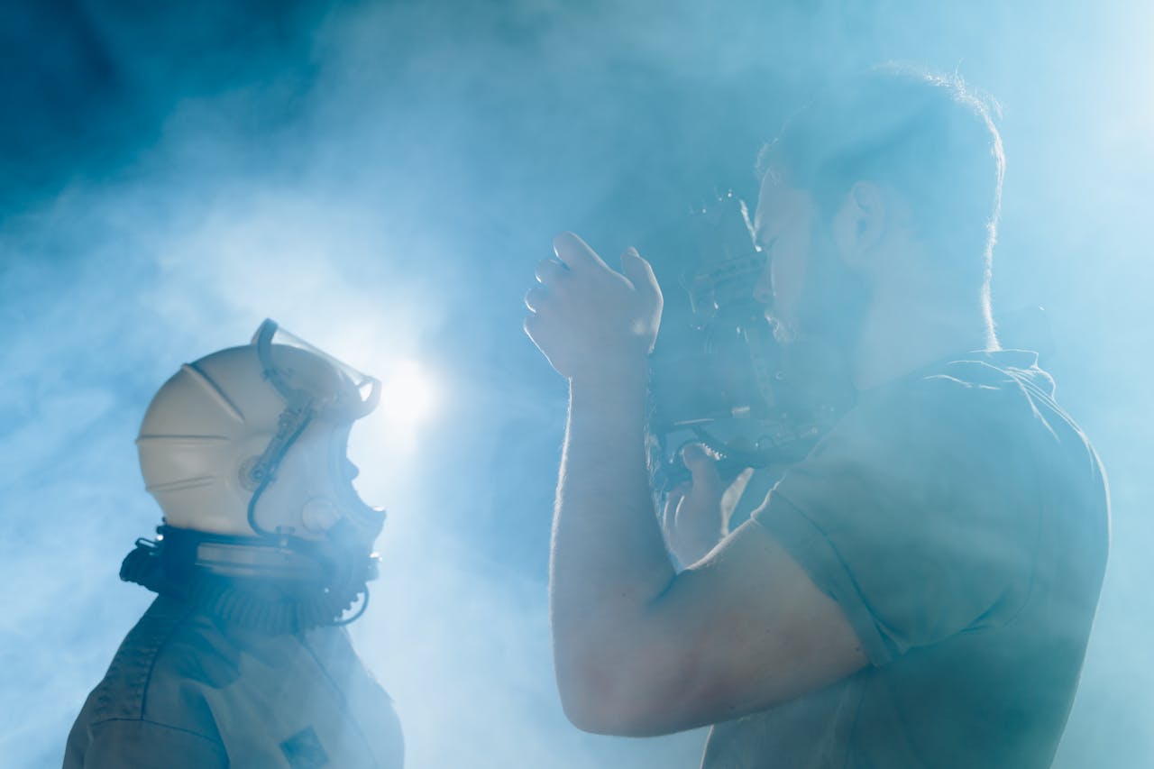 An astronaut and cameraman filming in a cinematic smokey atmosphere.